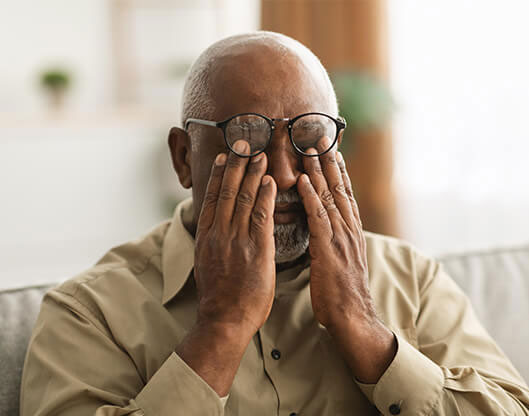 man dry eyes touching eye